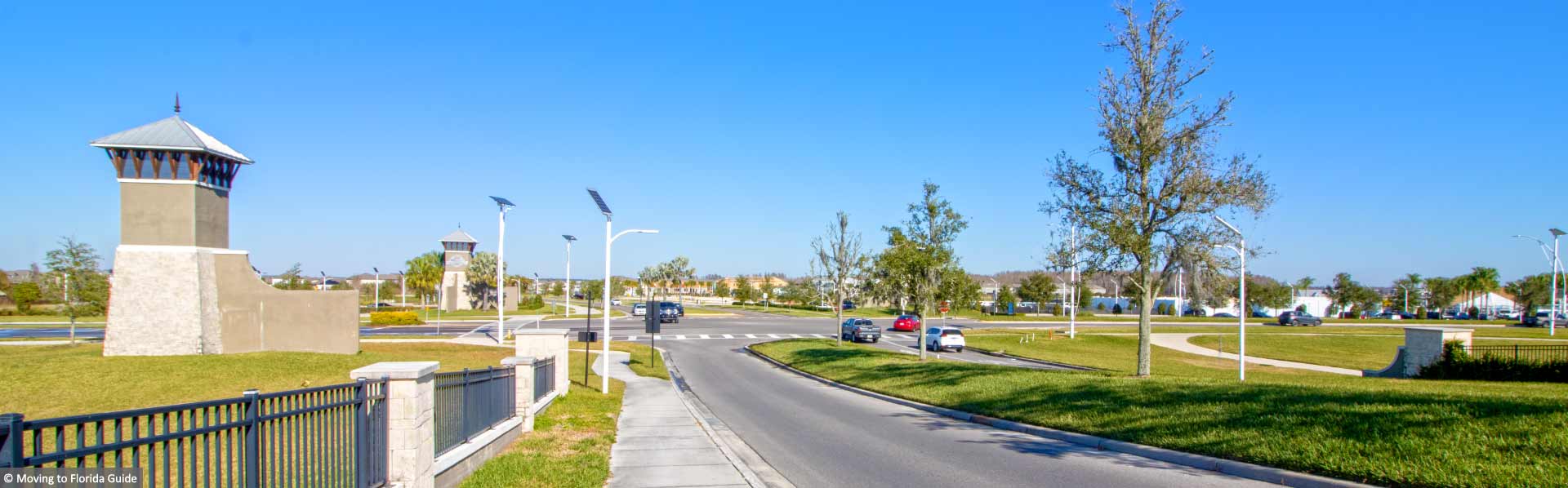 blue sky and green grass next to roadways