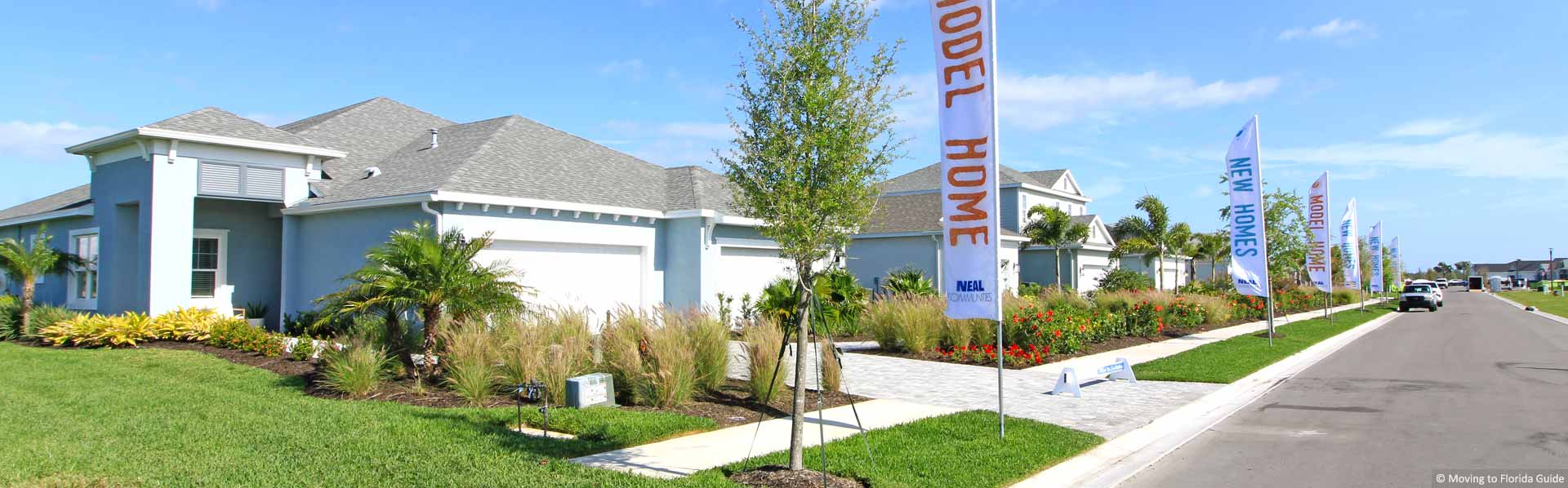 Street view of model homes with colorful banners
