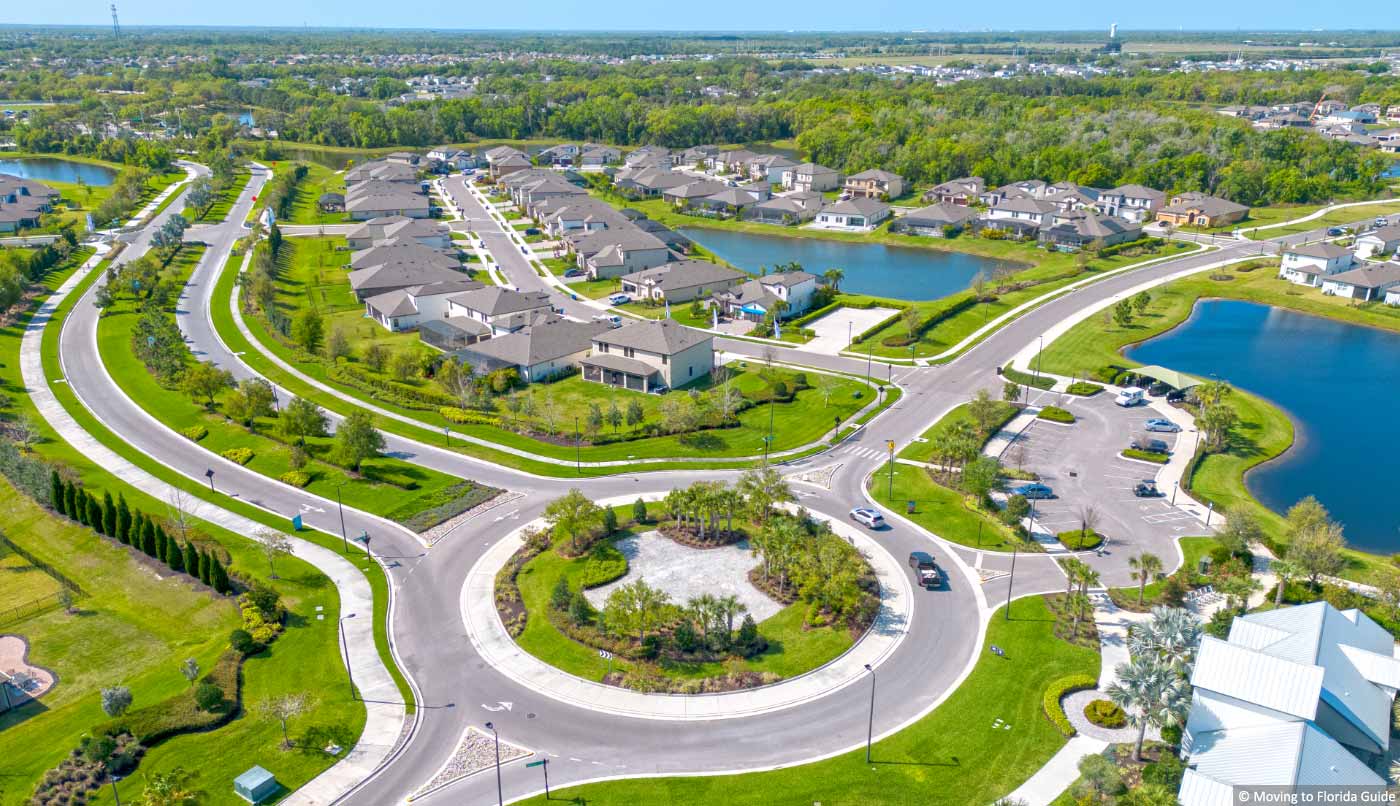 Aerial view of florida homes with water views and green grass