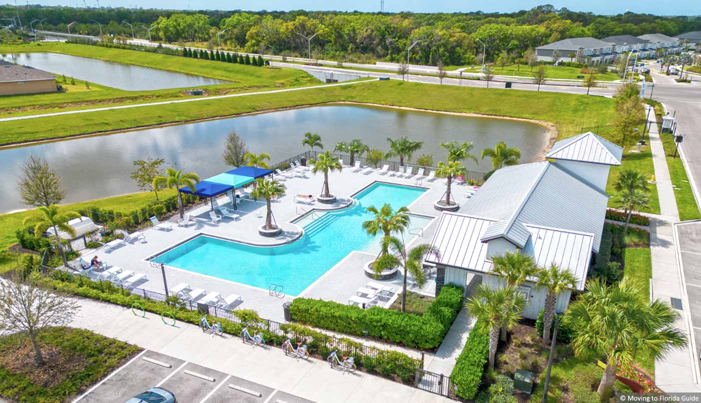 Aerial view of community swimming pool overlooking a lake