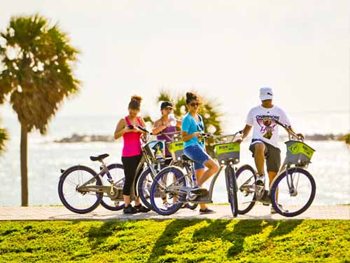 family on bicycles by the water