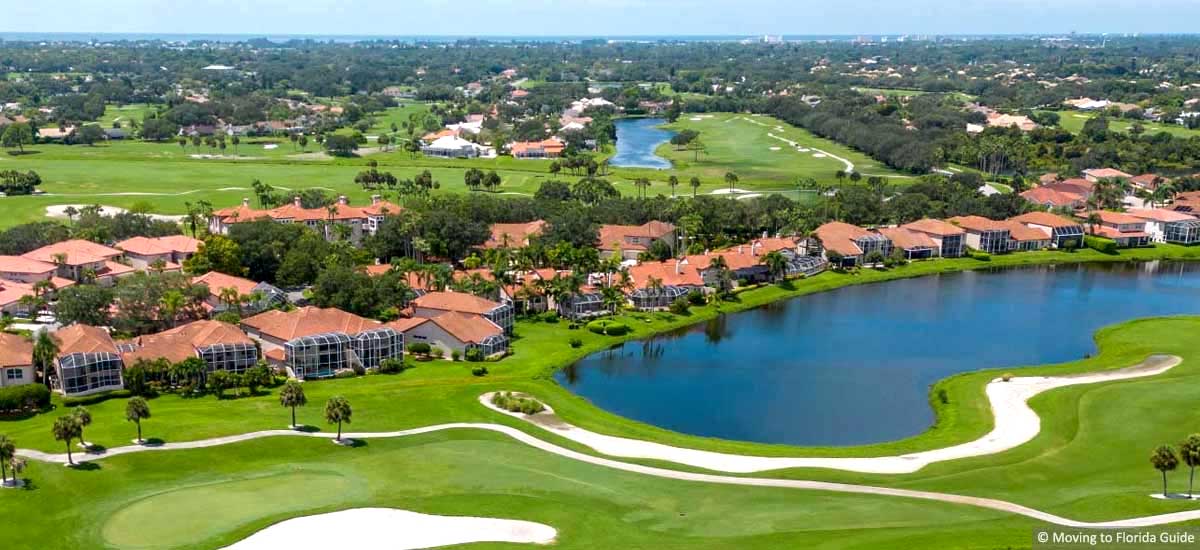 Florida housing community with tile roofs, golf and water views